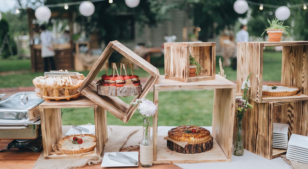 ondecoratedbuffettableinwoodenboxesarecakesand